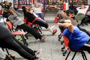 Participants perform chair-based abdominal crunches. PHOTO BY: JEFF MILLER