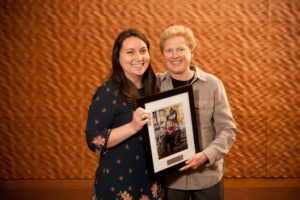 Erika Gallagher receives her award from Dean of Students Lori Berquam.