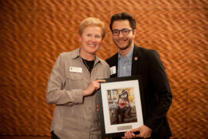 Jesus Del Toro receives has award from Dean of Syudents Lori Berquam.