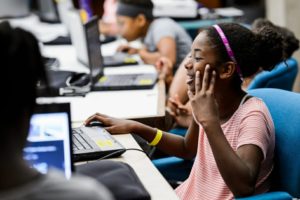 Shya Washington uses Scratch –- a modular, drag-and-drop computer-coding program — during the class “RoboSmarts: AI and the World.” PHOTO: JEFF MILLER