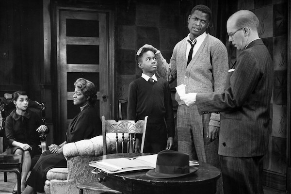 Scene from a 1959 production of the stage version of “A Raisin in the Sun.” From left: Ruby Dee (Ruth Younger), Claudia McNeil (Lena Younger), Glynn Turman (Travis Younger), Sidney Poitier (Walter Younger) and John Fiedler (Karl Lindner). All except Turman reprised their roles in the 1961 film. FRIEDMAN-ABELES PHOTOGRAPH COLLECTION
