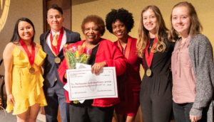 Leaders of the Chancellor's Scholars Class of 2019 presents a check representing their senior class gift to Program Director Gloria Hawkins. Photo by Amadou Kromah.