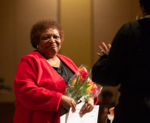 A surprise serenade by Milwaukee singer Kahlia Baker brought tears of joy to Dr. Gloria Hawkins at an unexpected celebration of her retirement. Photo by Amadou Kromah.