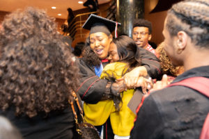2019 PEOPLE and McNair Graduate Tatiana Lipscomb shares a jubilant hug following the May 10, 2019 recognition ceremony. Phoo by Andy Manis.