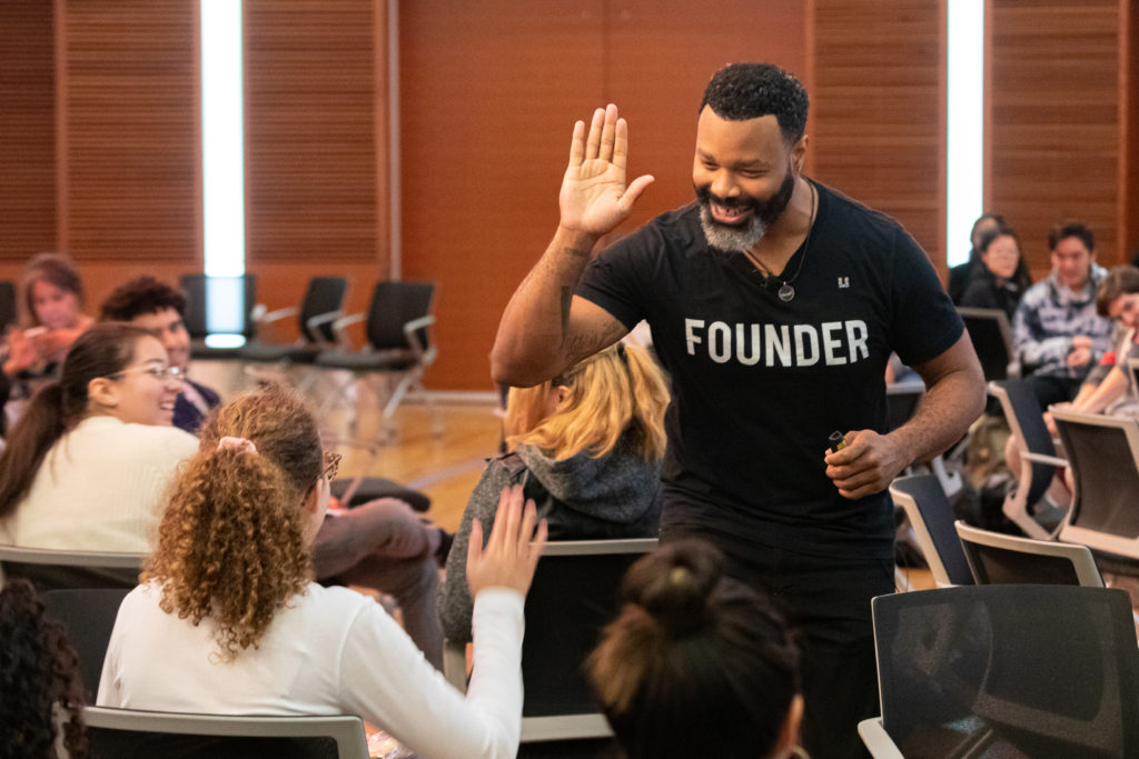 Entrepreneurship expert Thomas Stovall high-fives a workshop participant. Photo by Amadou Kromah