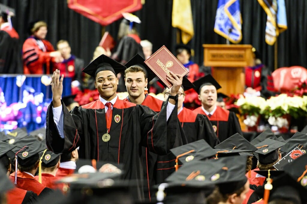 Graduate and Mercile J. Lee Scholar Brian Mays celebrates receiving his diploma. Photo by Bryce Richter