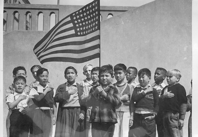 Children salute the American Flag at Raphael-Weil School.