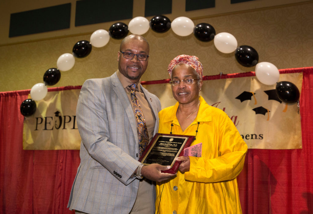 Vice Provost & Cheif Diversity Officer Patrick J. Sims presents keyote speaker Hazel Symonette with the Lane DeWalt Service Award at the annual Rwecognition Banquet PEOPLE Banquet, July 21, 2017. DDEEA photo by Andy Manis. 