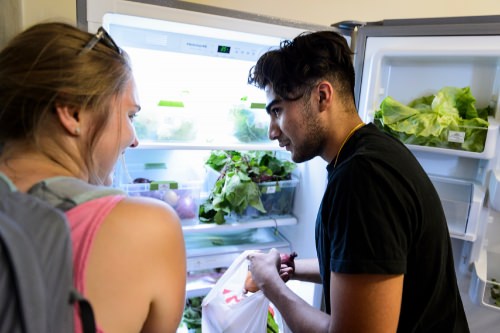 Undergraduates Edie Africano and Tanveer Vasdev help themselves to refrigerator-stored vegetables and produce at the Food Shed, PHOTO: JEFF MILLER