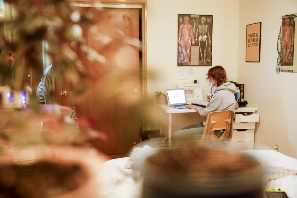 Pre-nursing student, Victoria Mingle works on coursework in her Madison apartment bedroom. RUTHIE HAUGE