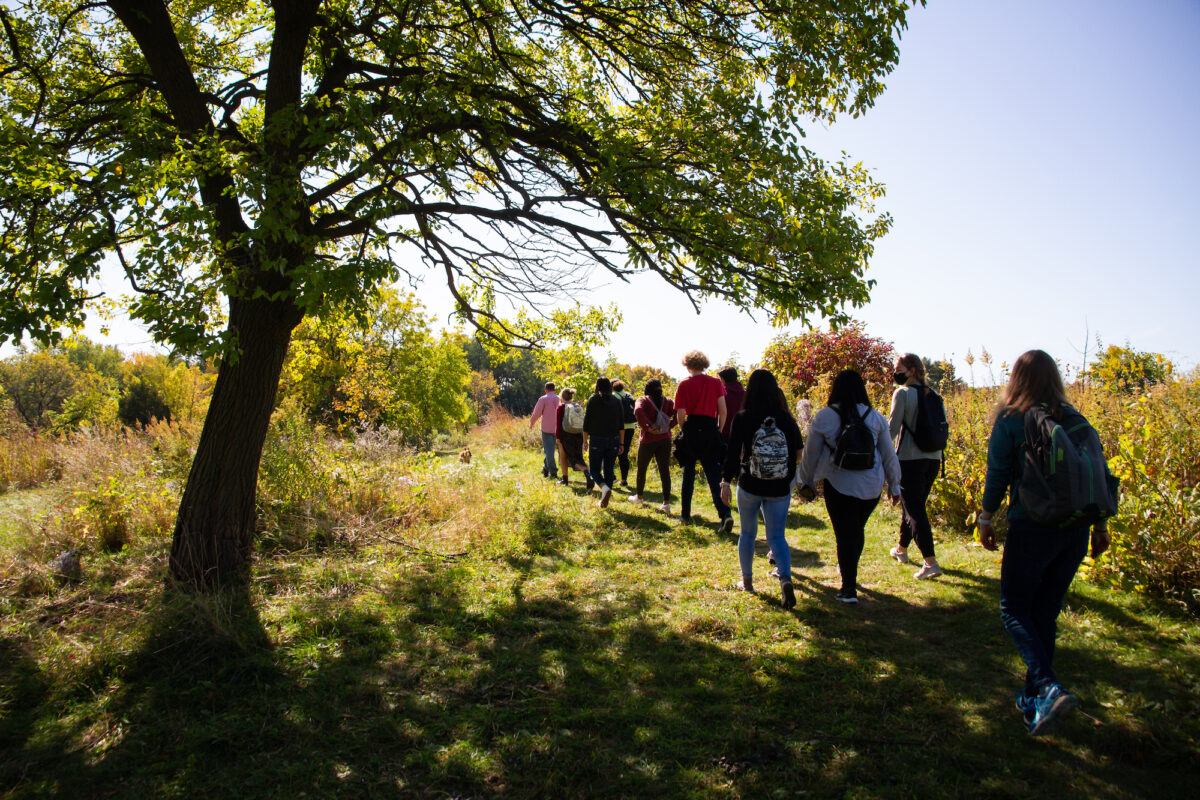 Instructor Dan Cornelius leads students through the Biocore Prairie near Picnic Point during an agricultural workshop for the First-Year Interest Group “Listening to Land: Indigenous Education, Language, and Foodways.” PHOTO: CATHERINE REILAND/UW–MADISON
