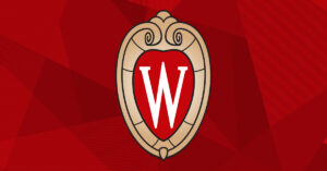 The UW–Madison crest over a red patterned background