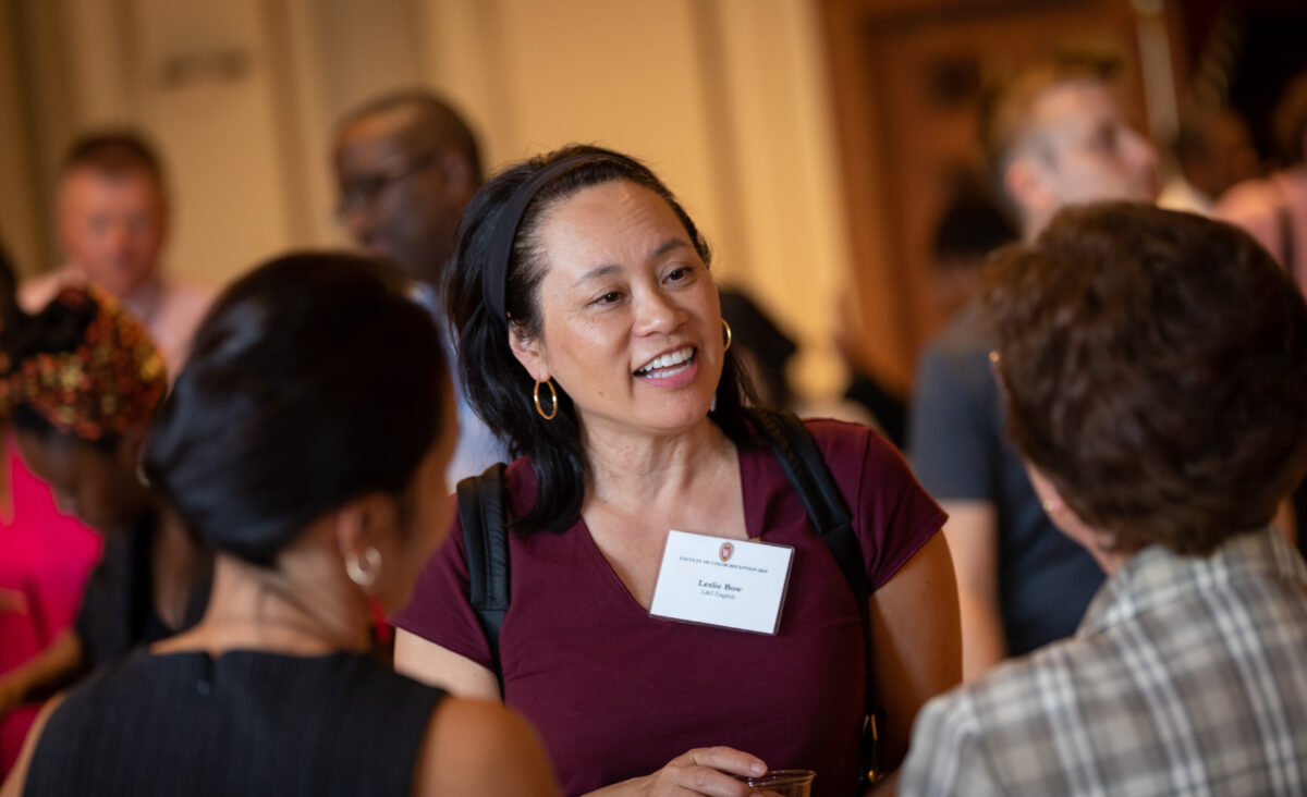 People talk while standing in a small group