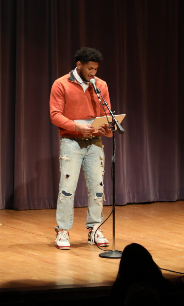 Justin Russel reads his poetry at a performance