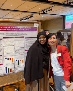 DDEEA scholar posing with advisor Hyewon Park in front of their research poster at the Undergraduate Research Symposium